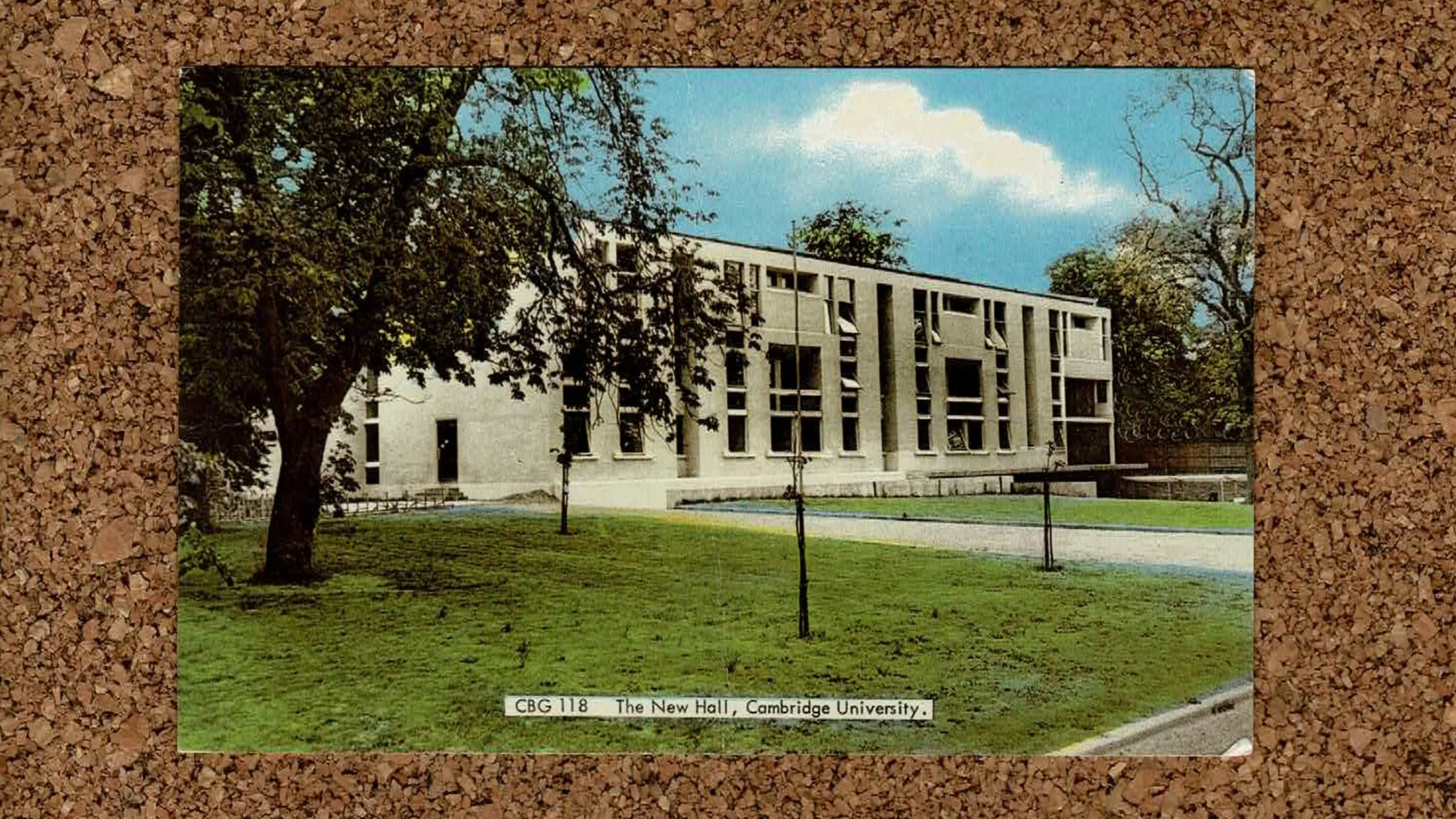 Image of Cambridge Murray Edwards College postcard on a cork background