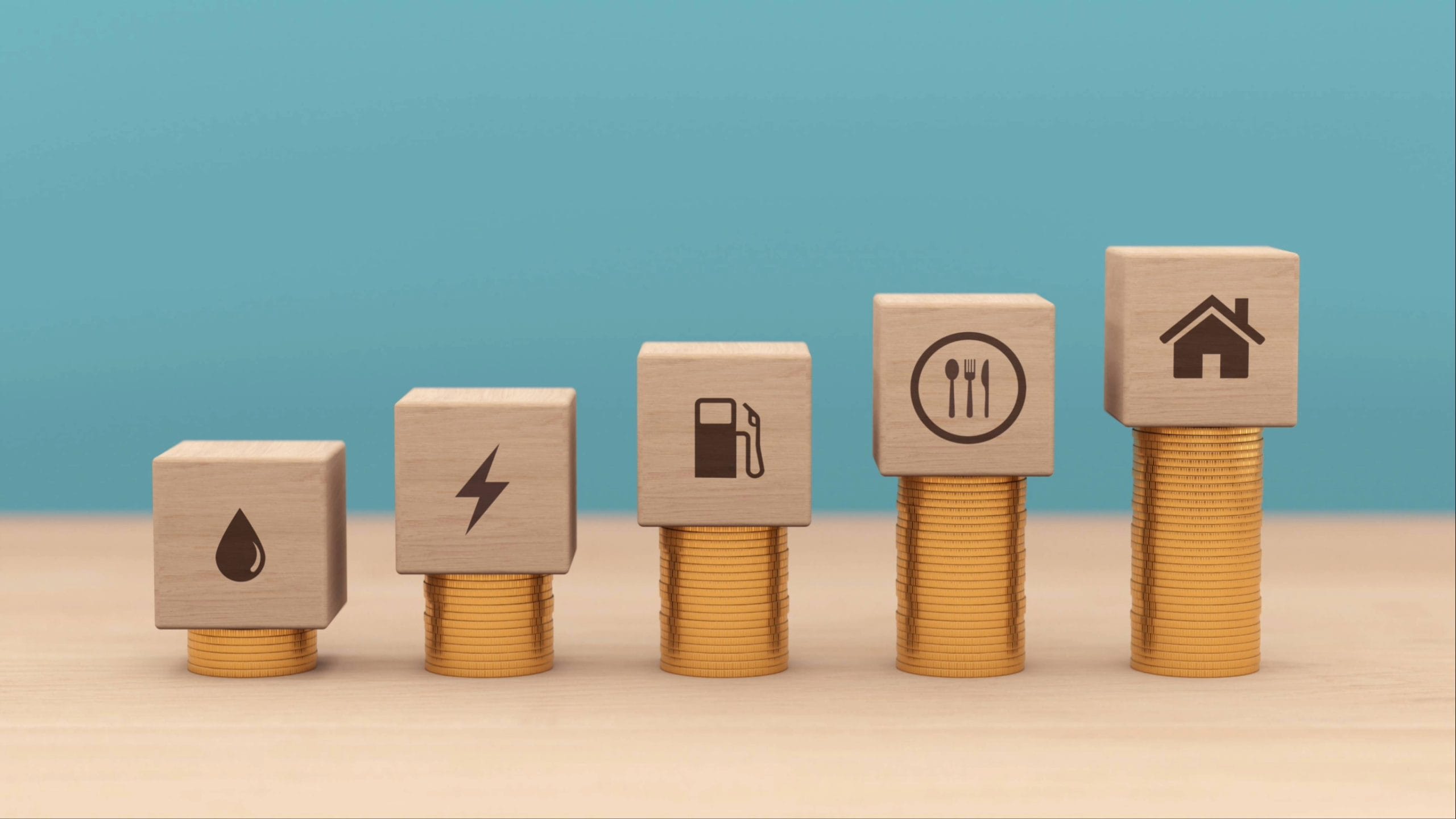 Image of stacks of coins with wooden blocks denoting rising cost of living